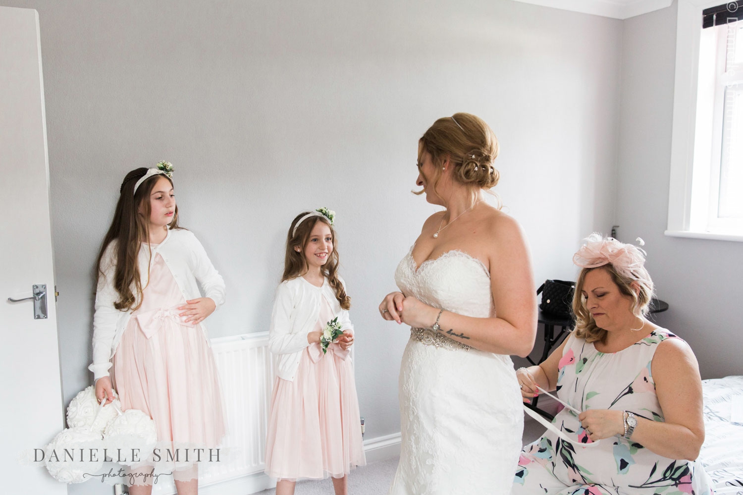 bride having back of dress done up