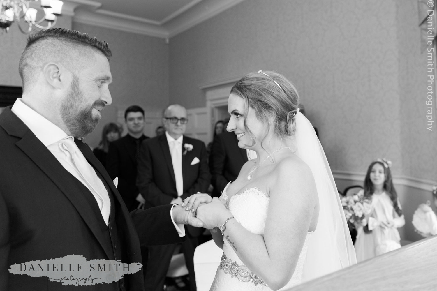 bride and groom exchanging rings at langtons