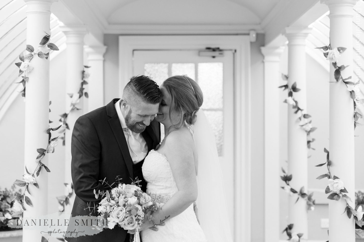 bride and groom snuggling indoors