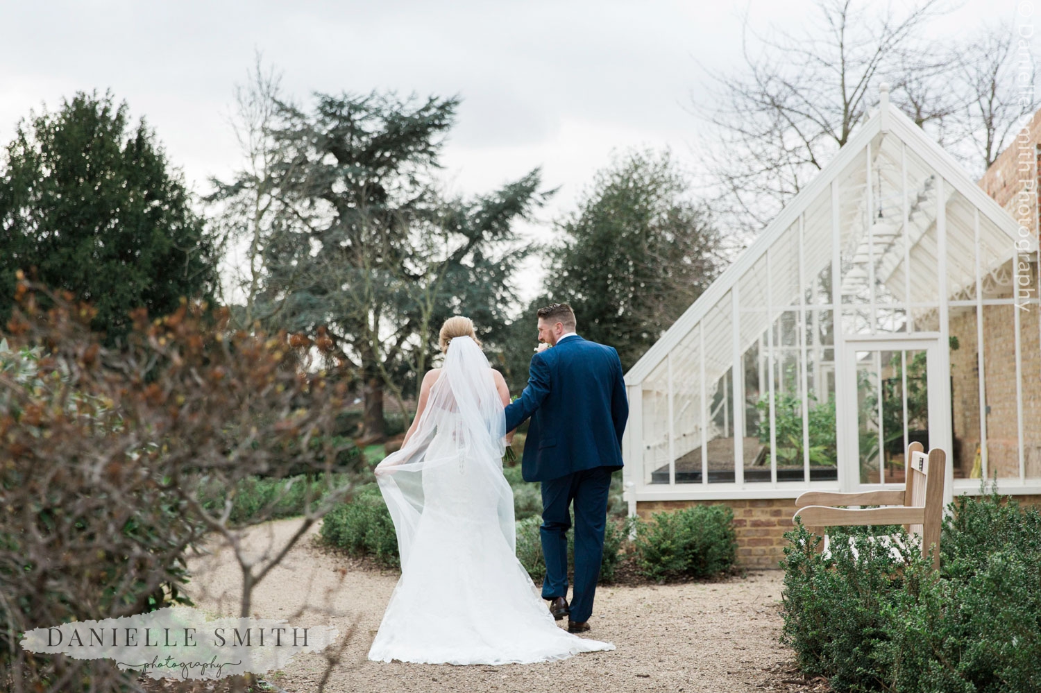 bride and groom walking through gardens at langtons