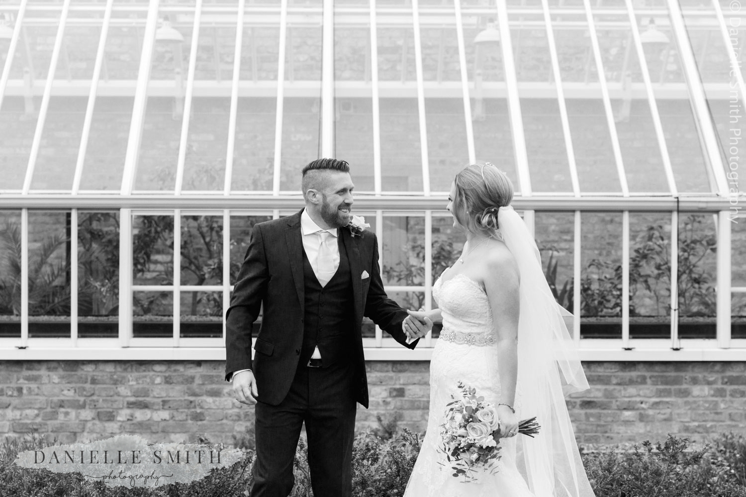 bride and outside in front of green house