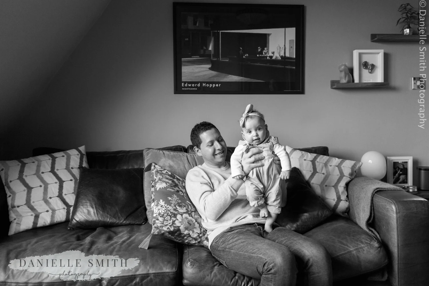 baby girl standing on dads lap