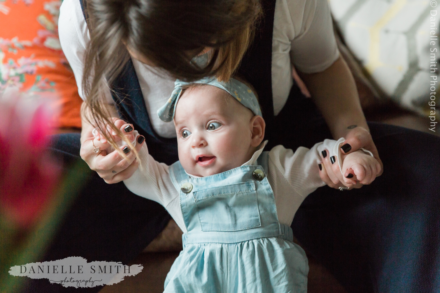 mum holding baby girl up - natural family photos
