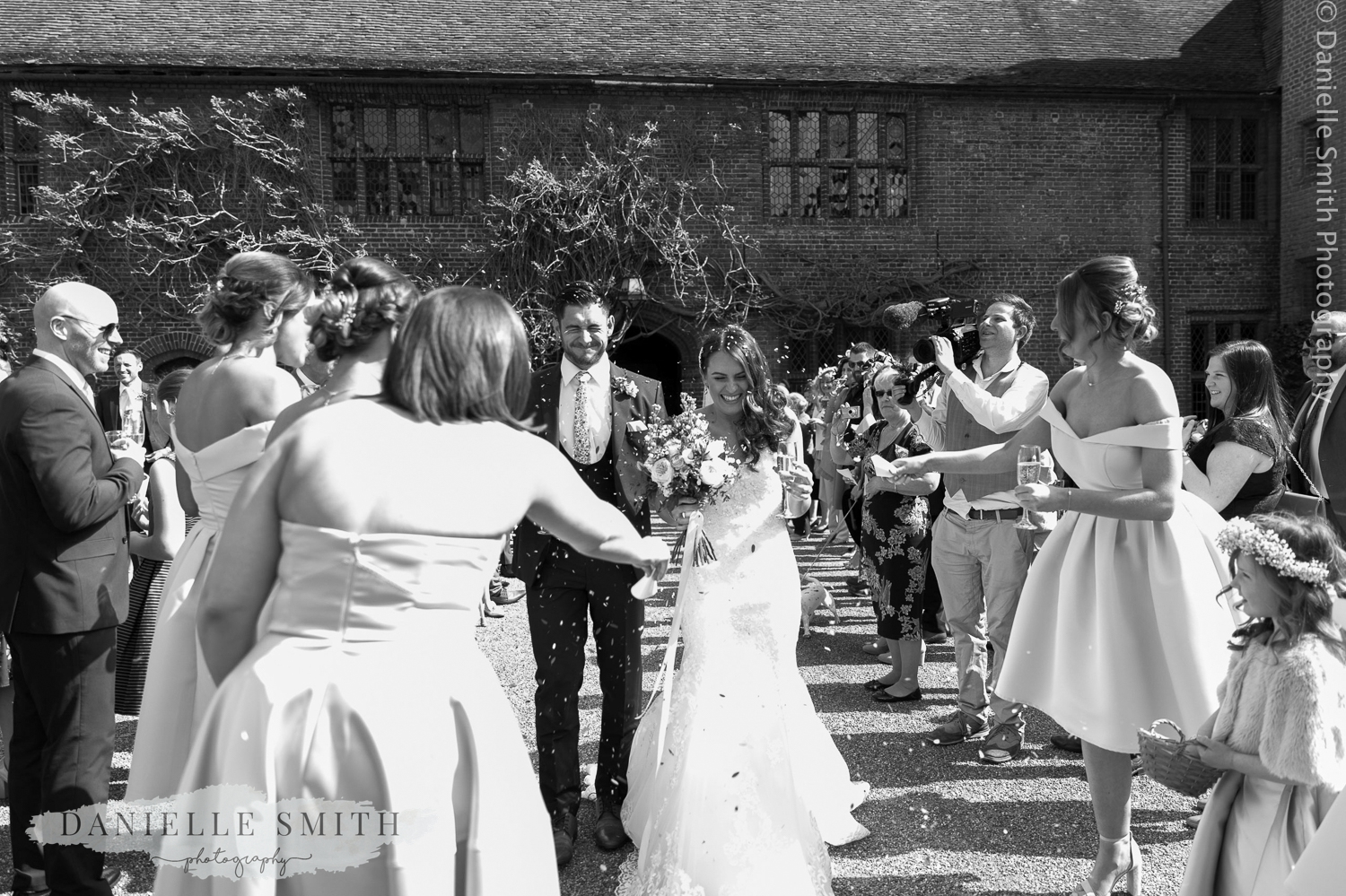 bride and groom walk through guests with confetti