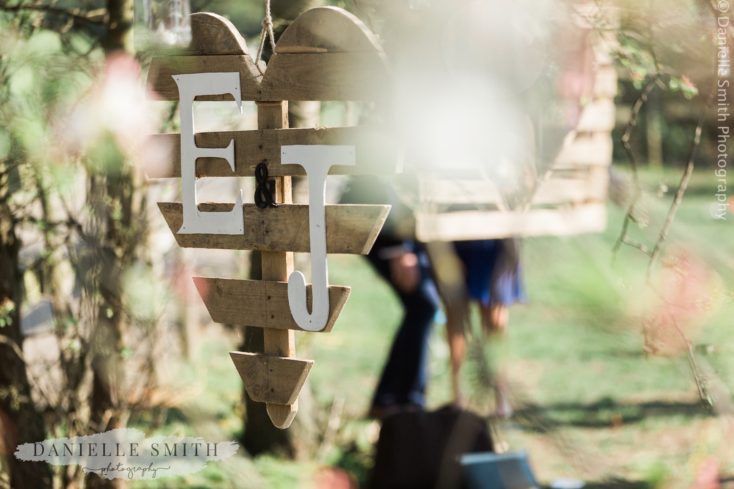 initials on wooden heart at garden wedding