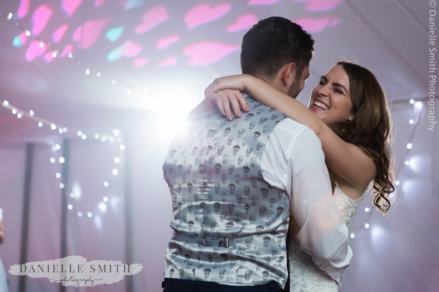 bride and grooms first dance in marquee wedding