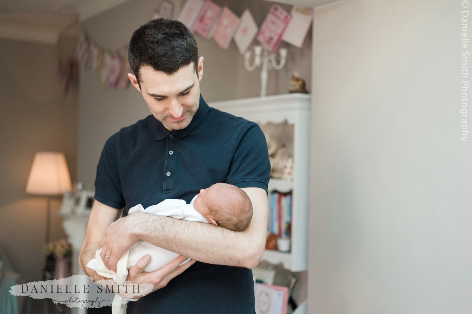 dad holding newborn baby - natural newborn photography