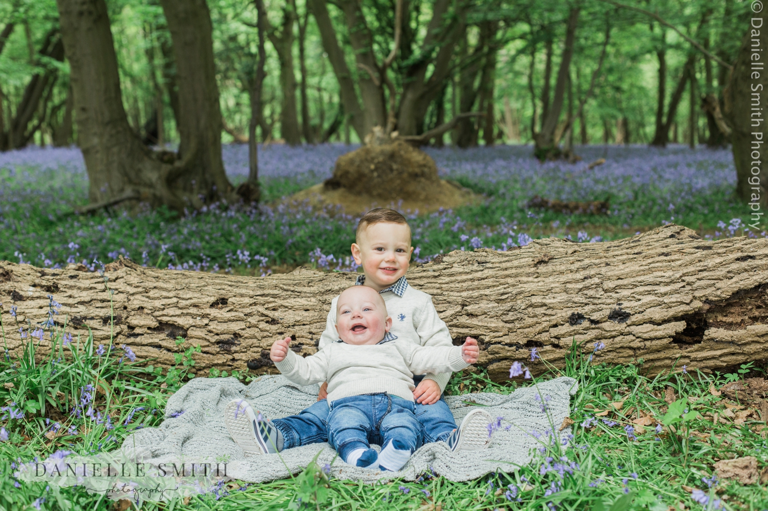 young brothers hugging in bluebells photo shoot