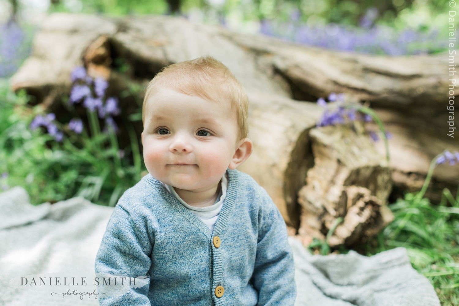 close up of baby boy in bluebell woods