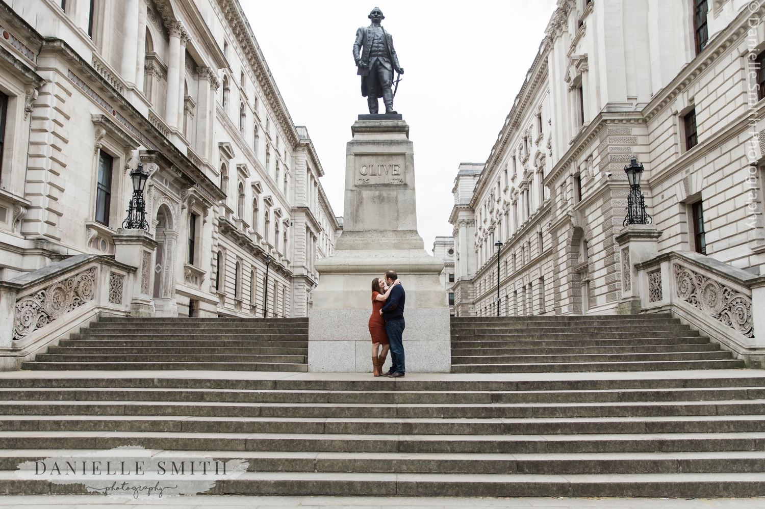 couple standing by statue in westminster