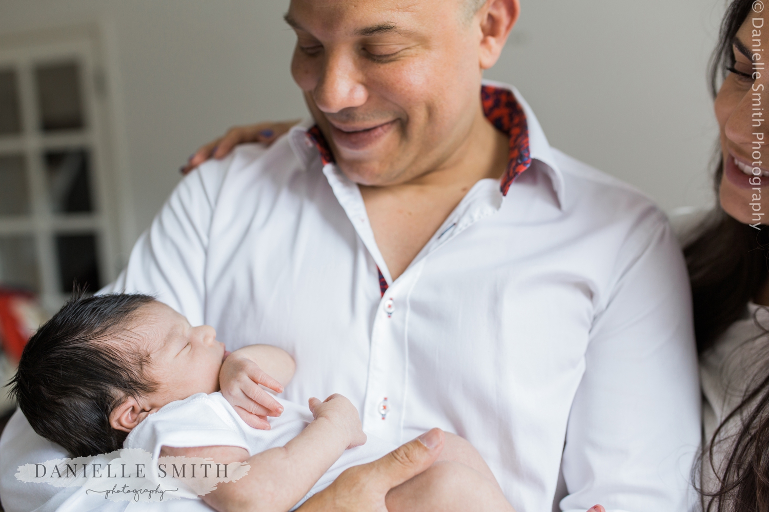 mum and dad with newborn baby at home