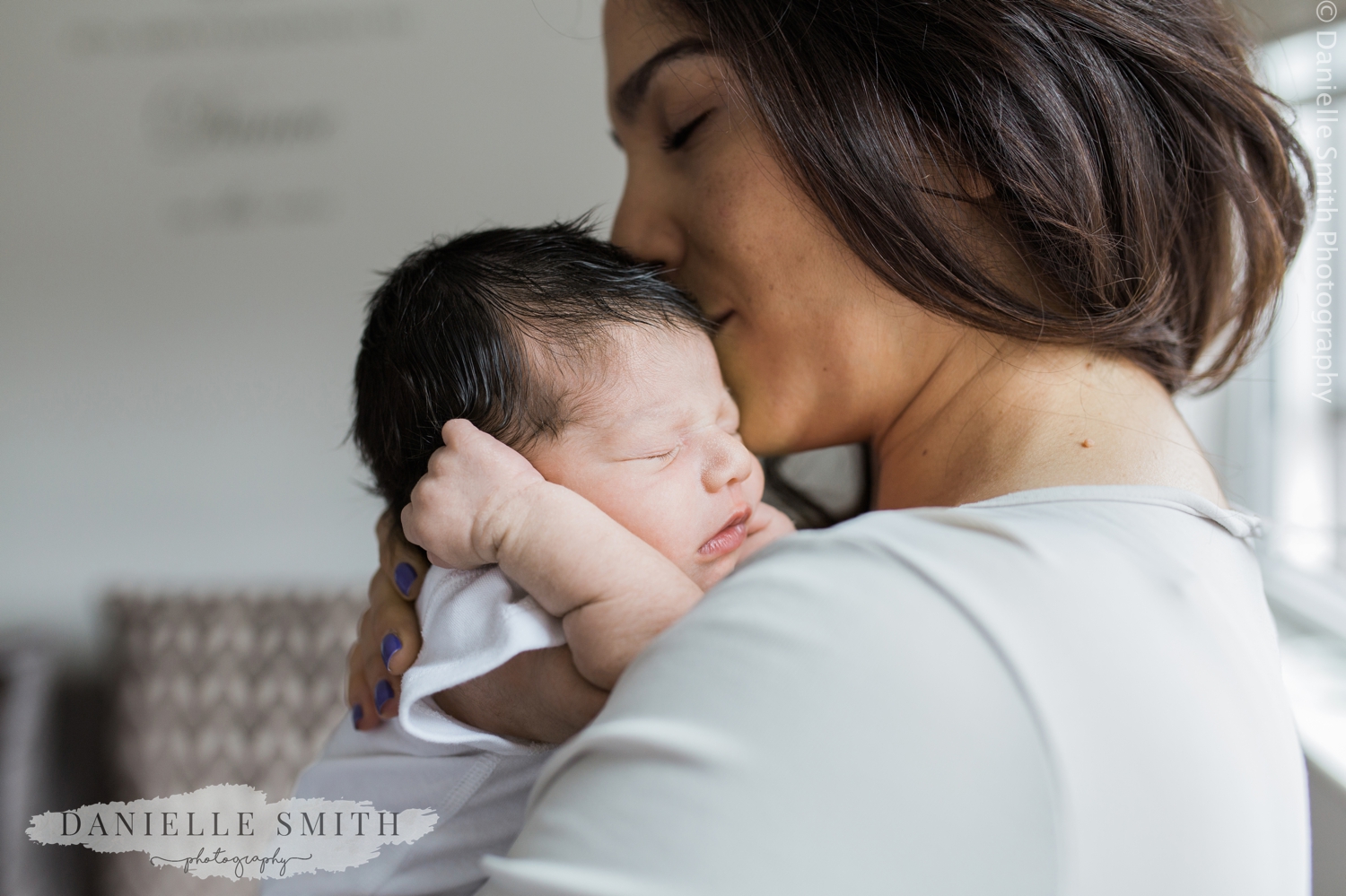 mum kissing baby's head