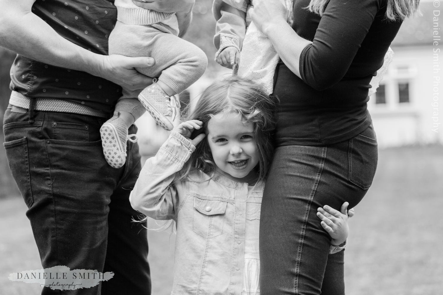 little girl hugging mums leg