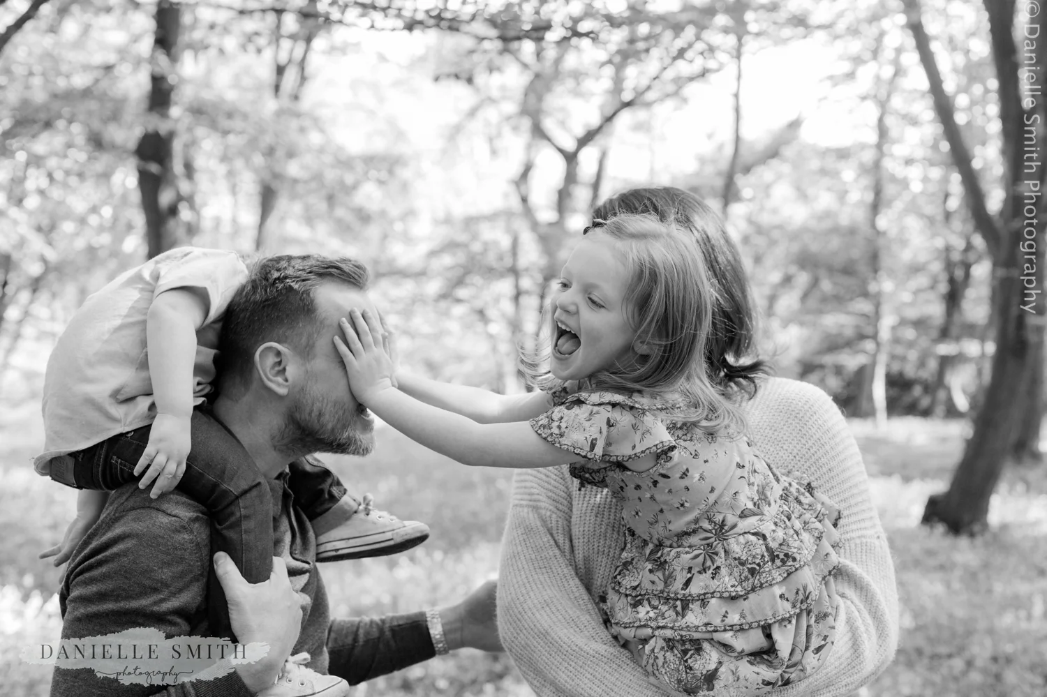 family having fun in forest - bluebells family photos
