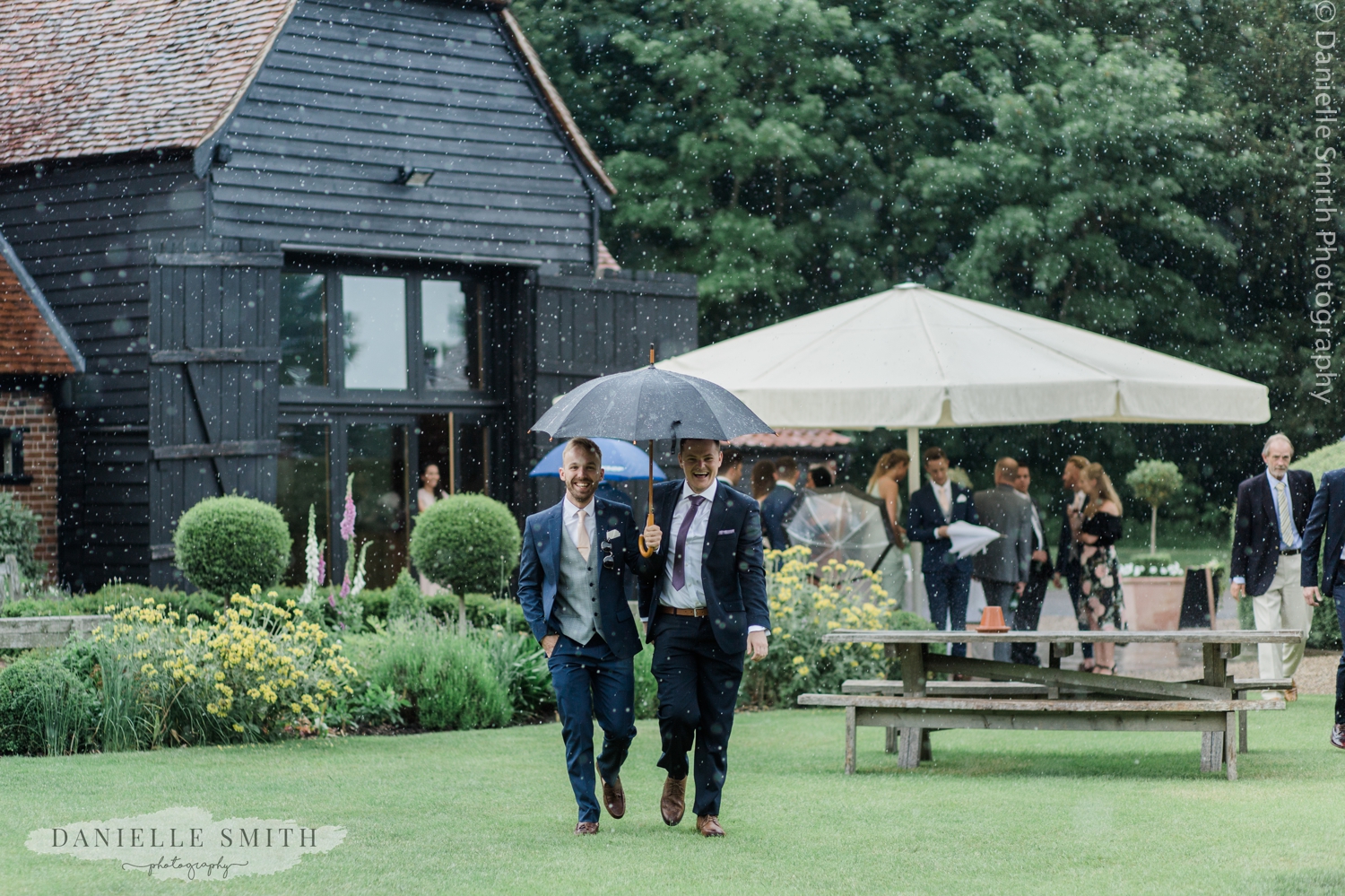 wedding guests with umbrella