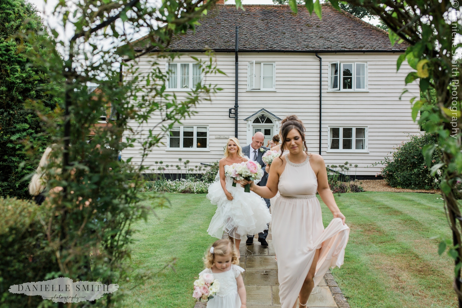 bridesmaids getting ready to walk down aisle
