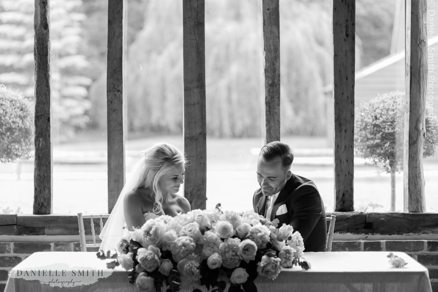 bride and groom signing the register at blake hall ongar