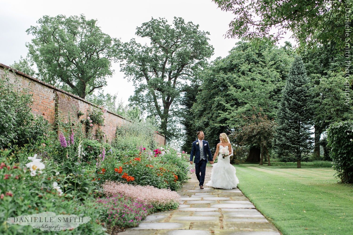 blame hall gardens - bride and groom walking