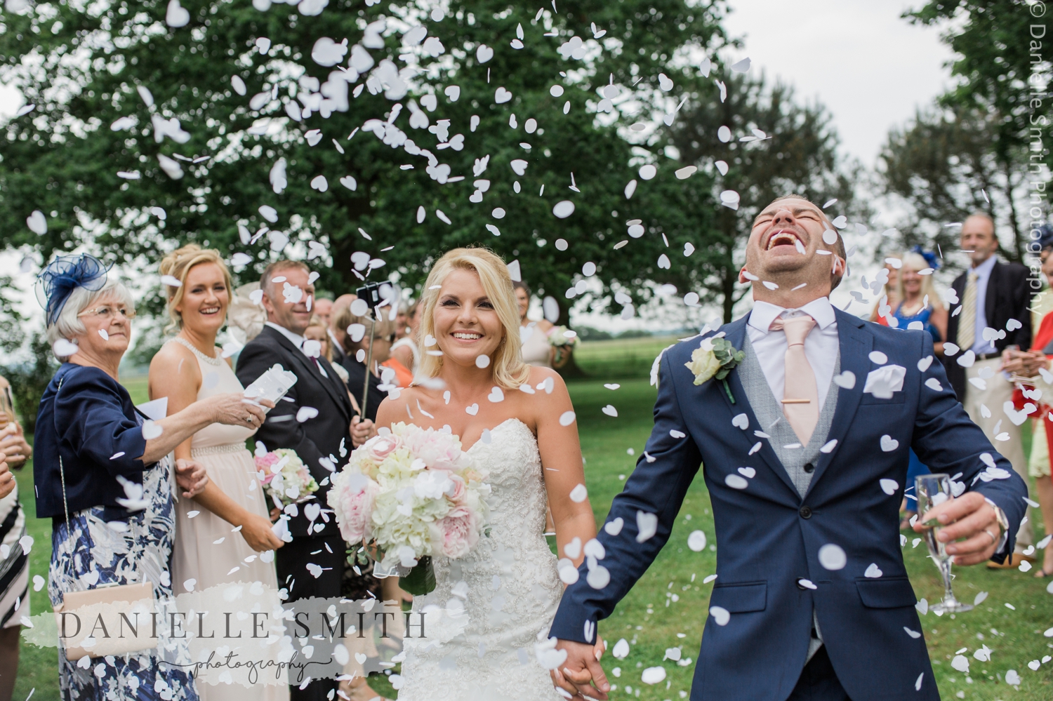 groom laughing head off during confetti