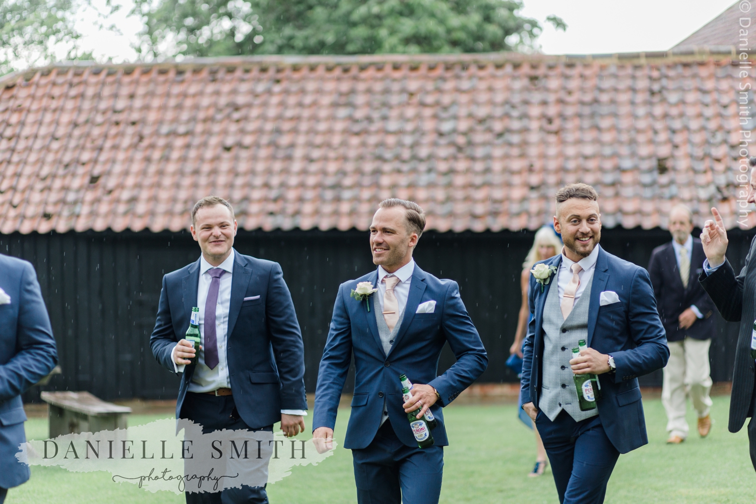 groomsmen walking in gardens