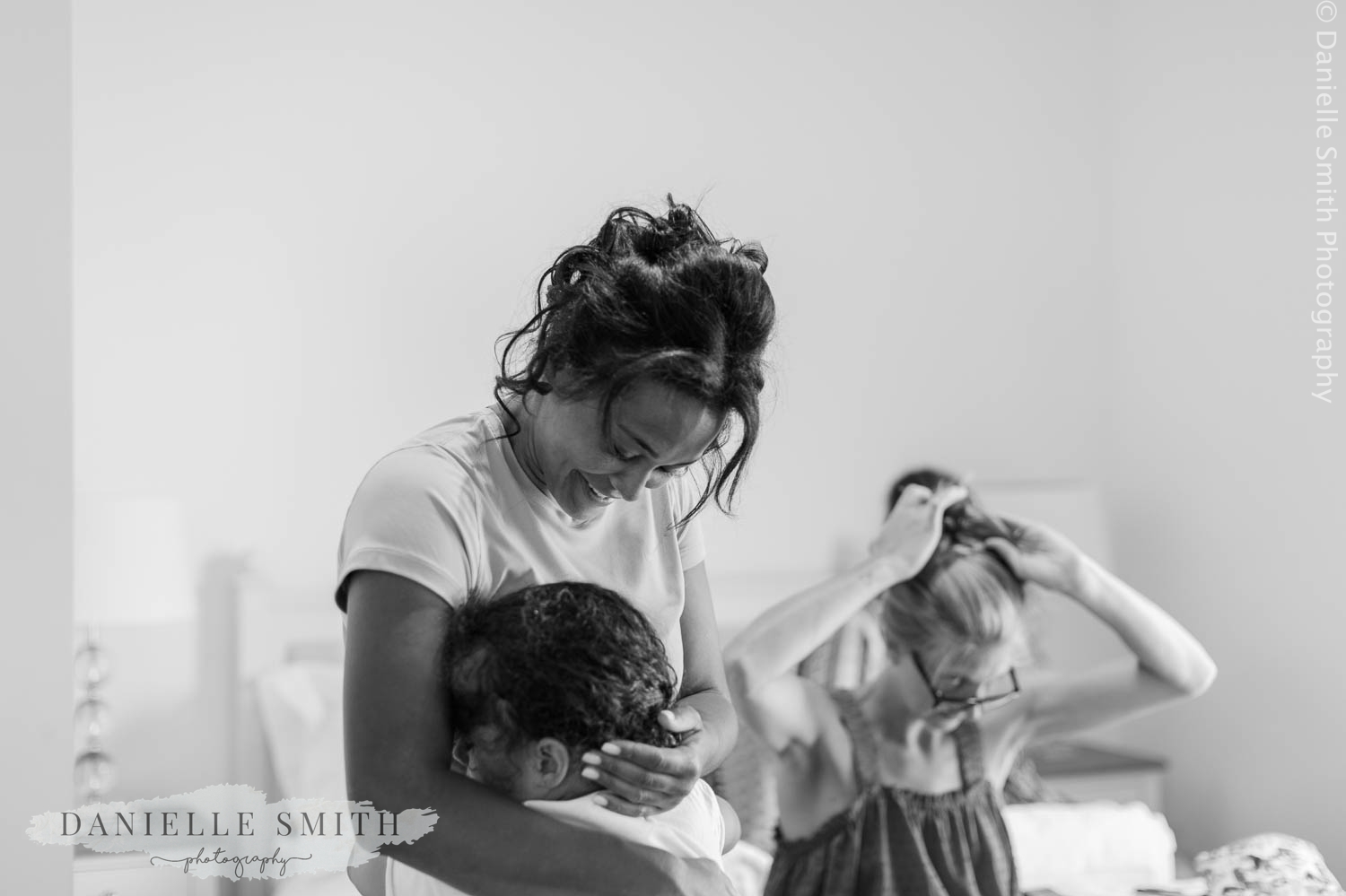 bride hugging her daughter on morning of wedding