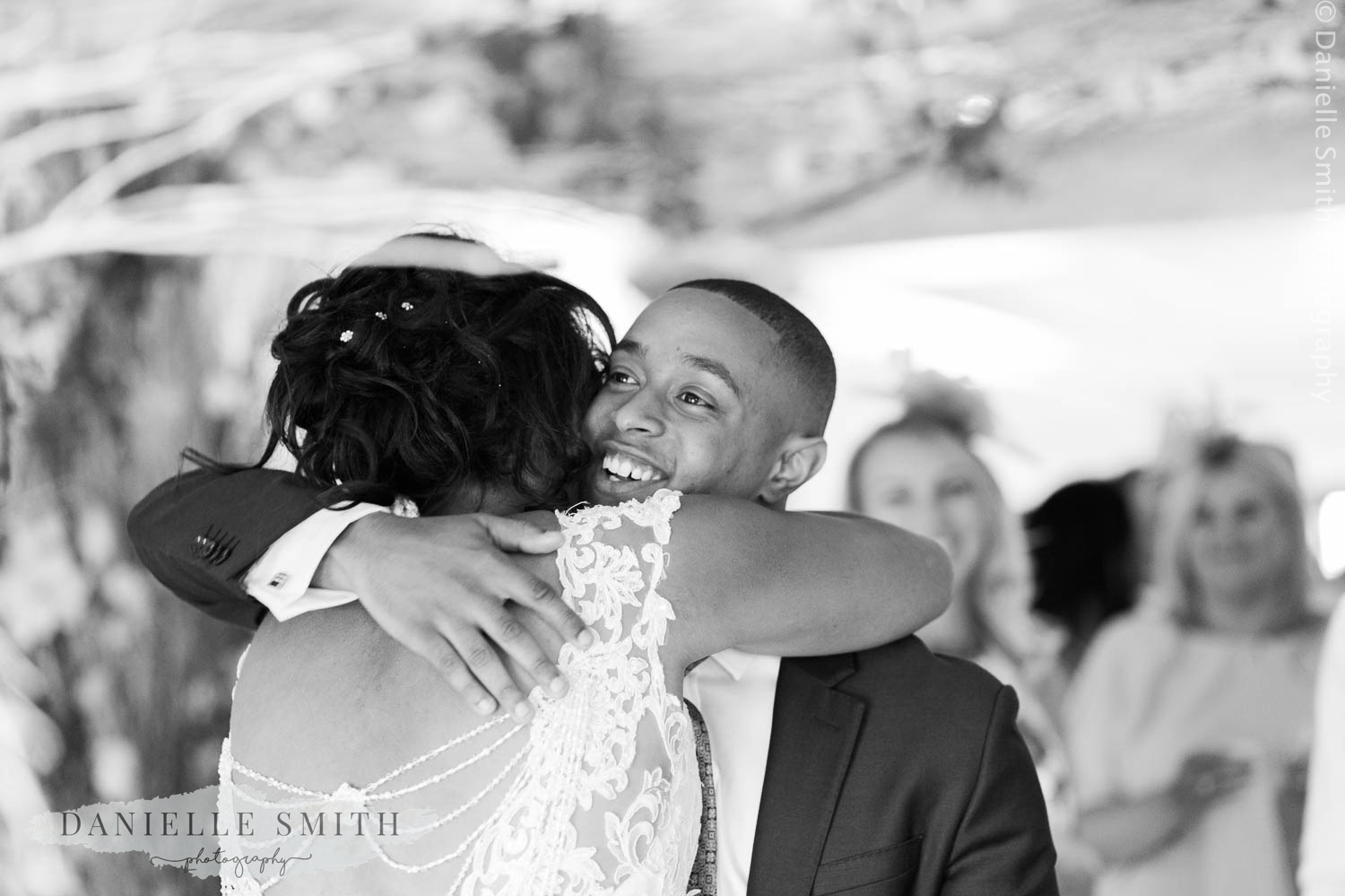 guests hugging bride