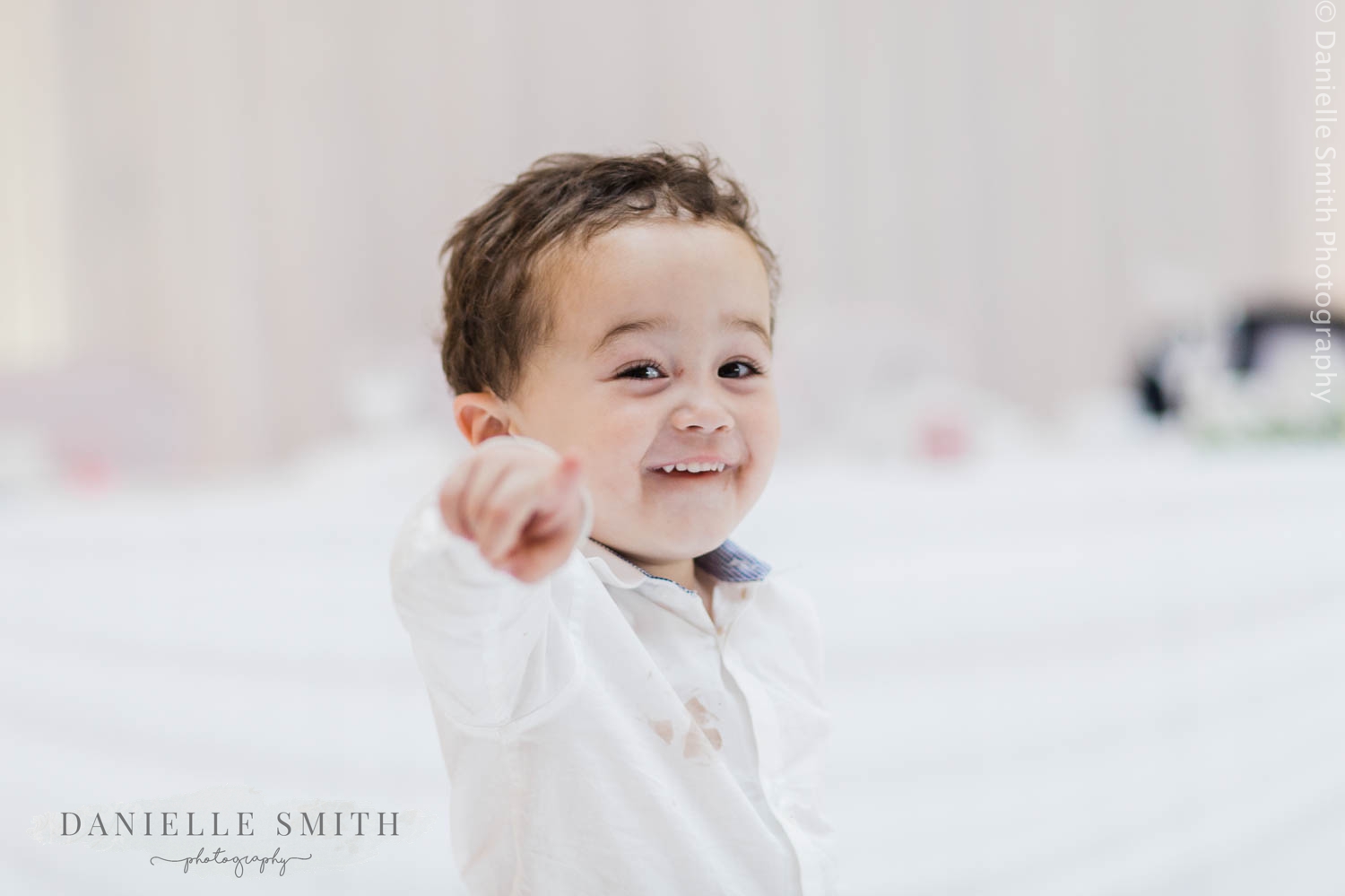 little boy pointing at camera