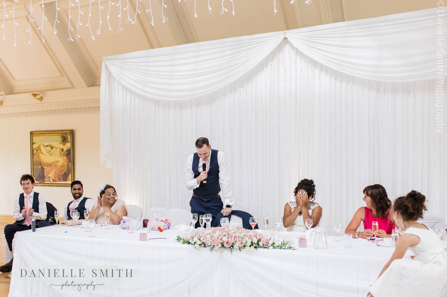 top table while groom gives speech