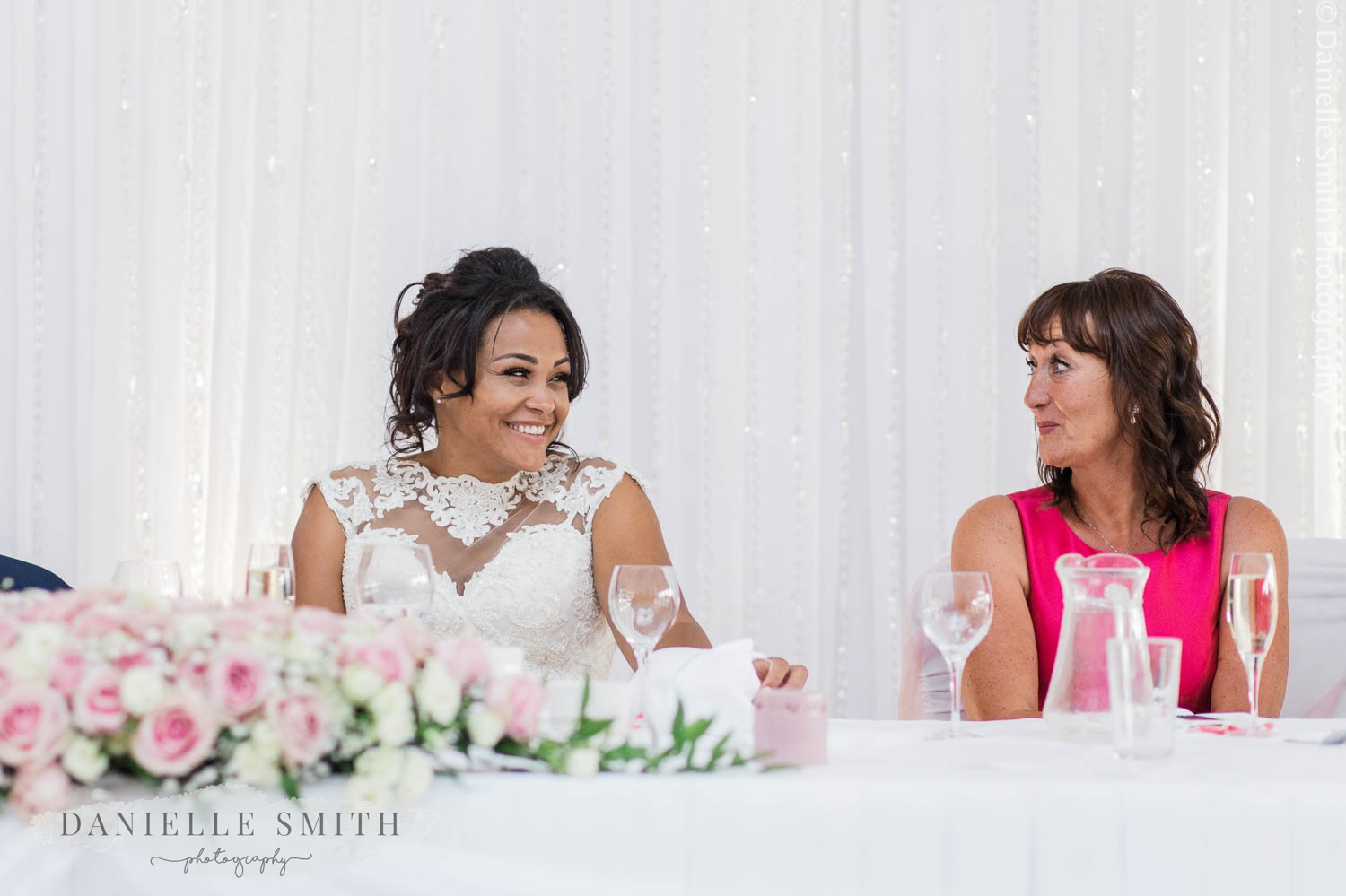 bride smiling at grooms mother