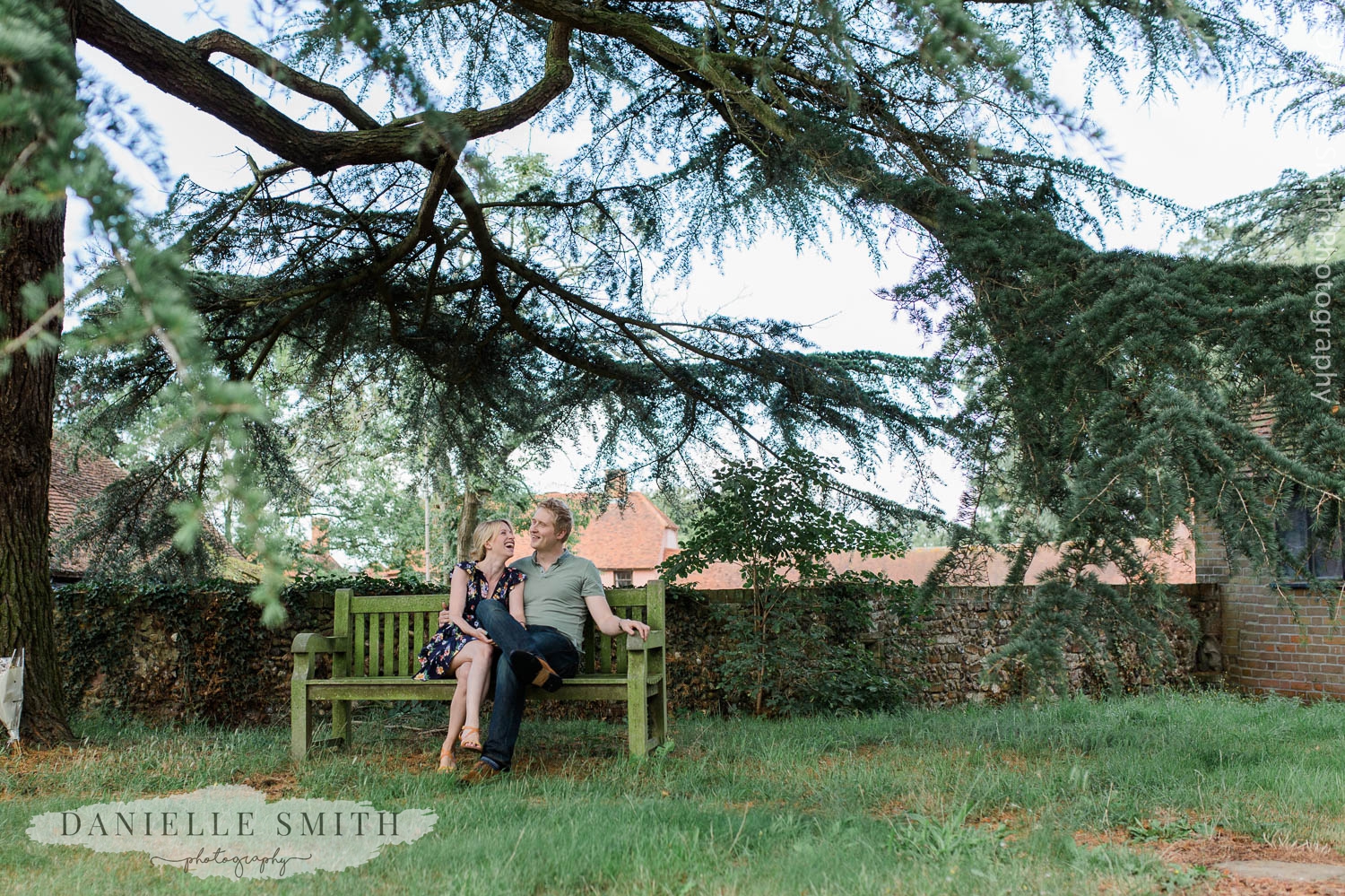 couple sitting on bench at little easton church
