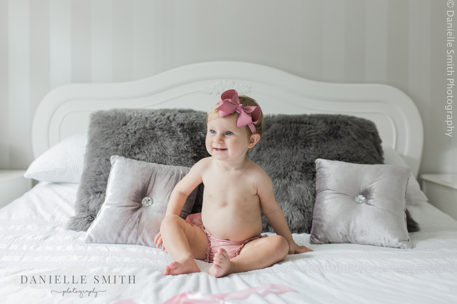 little girl with bow on head - first birthday photo shoot