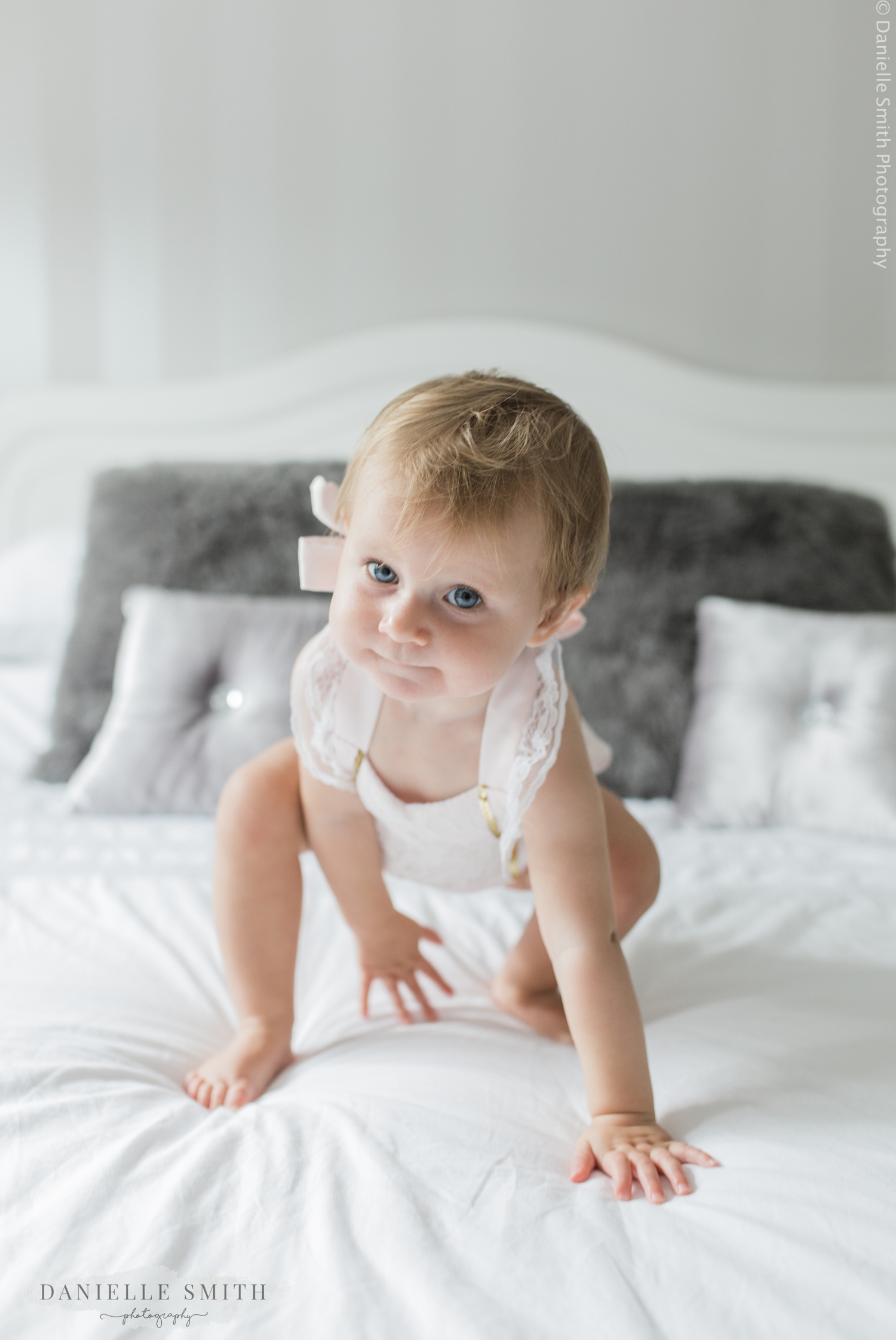 little girl crawling on bed