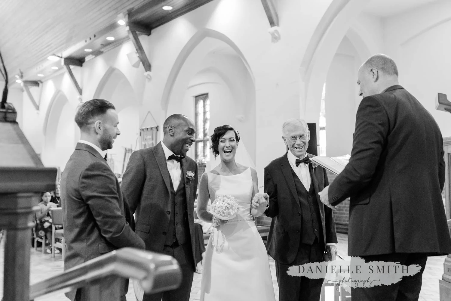 bride and groom laughing during church service