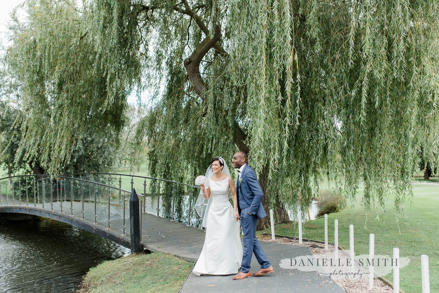 bride and groom with bridge and willow tree