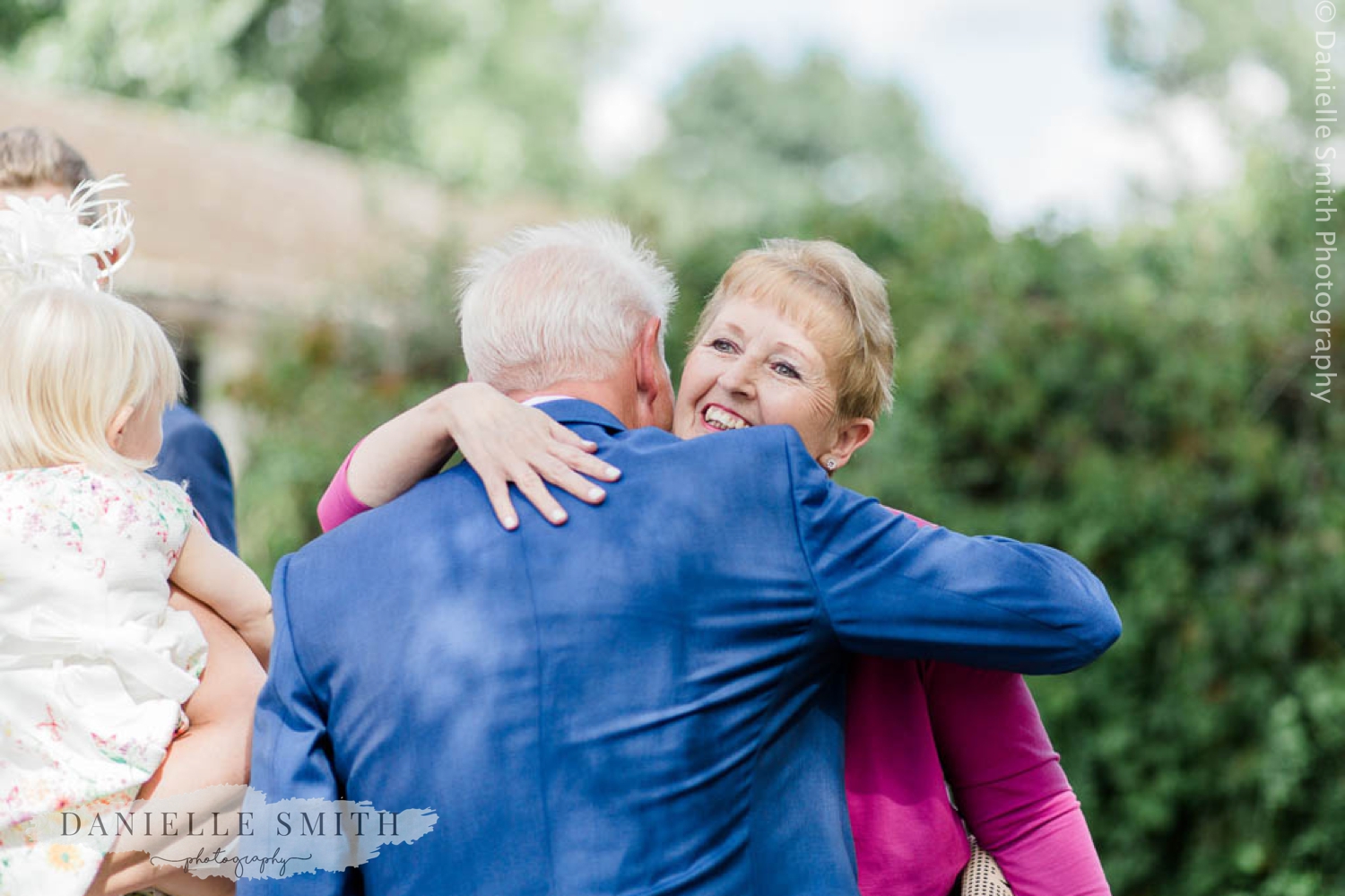 groom hugging wedding guest