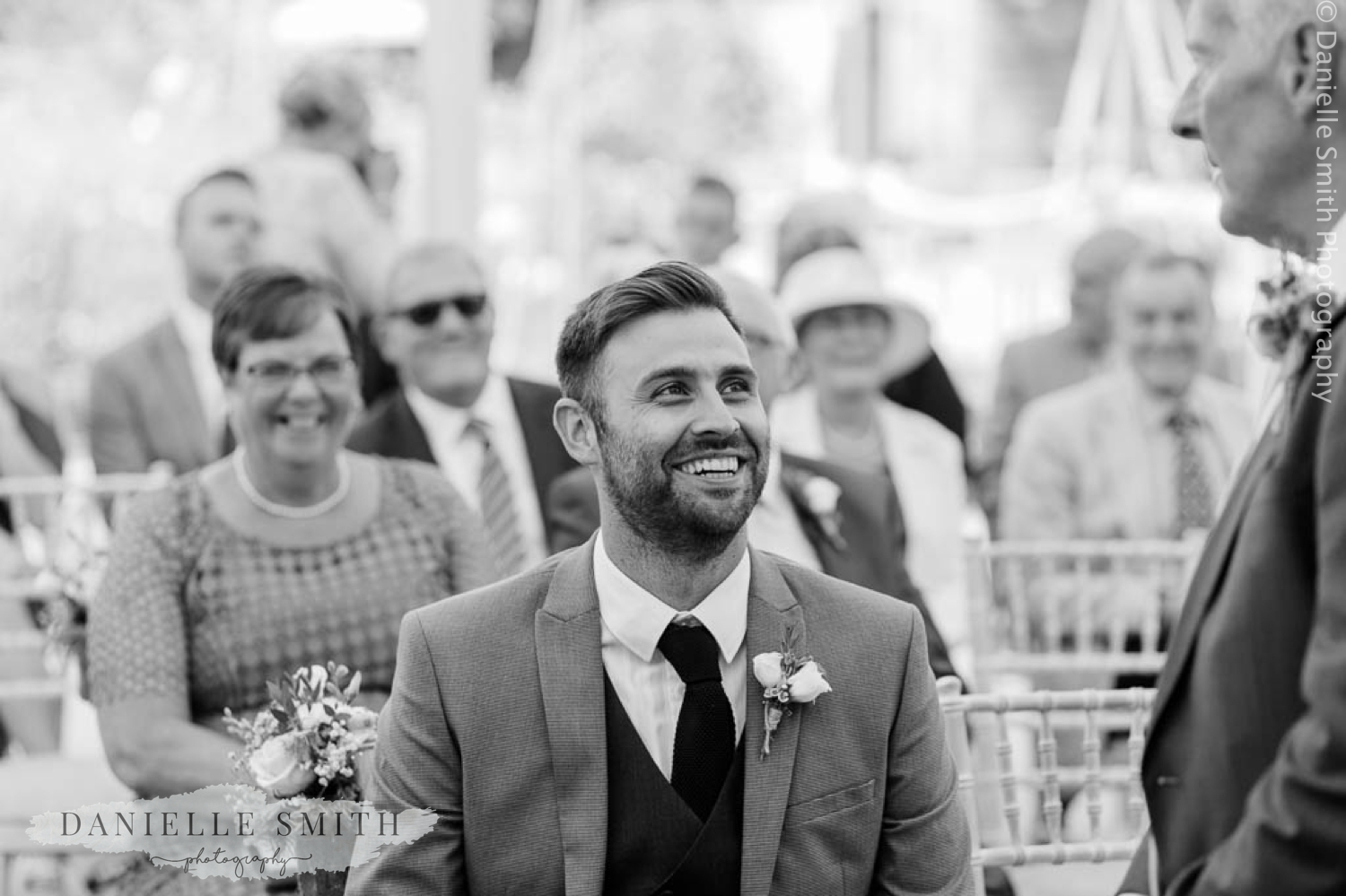 man laughing during ceremony