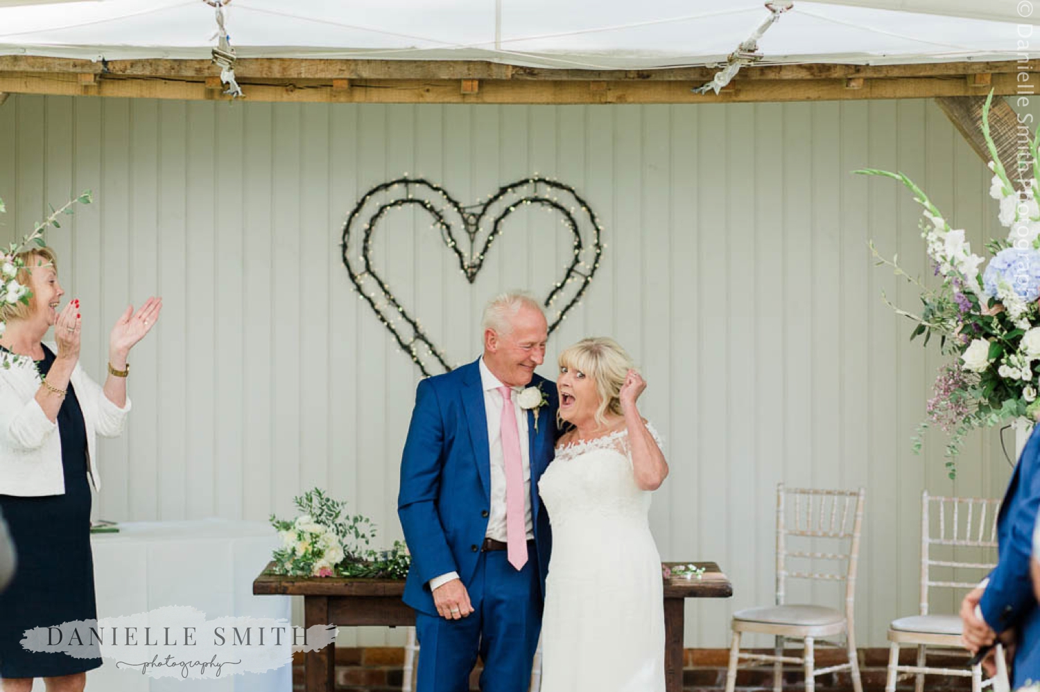 bride and groom cheering after married - houchins wedding photographer