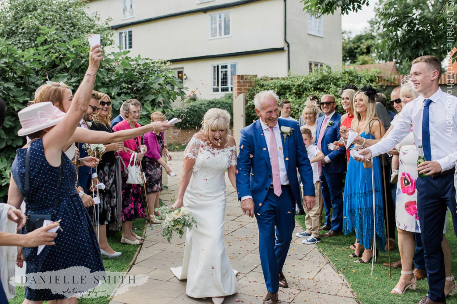 guests throwing confetti over bride and groom - houchins wedding