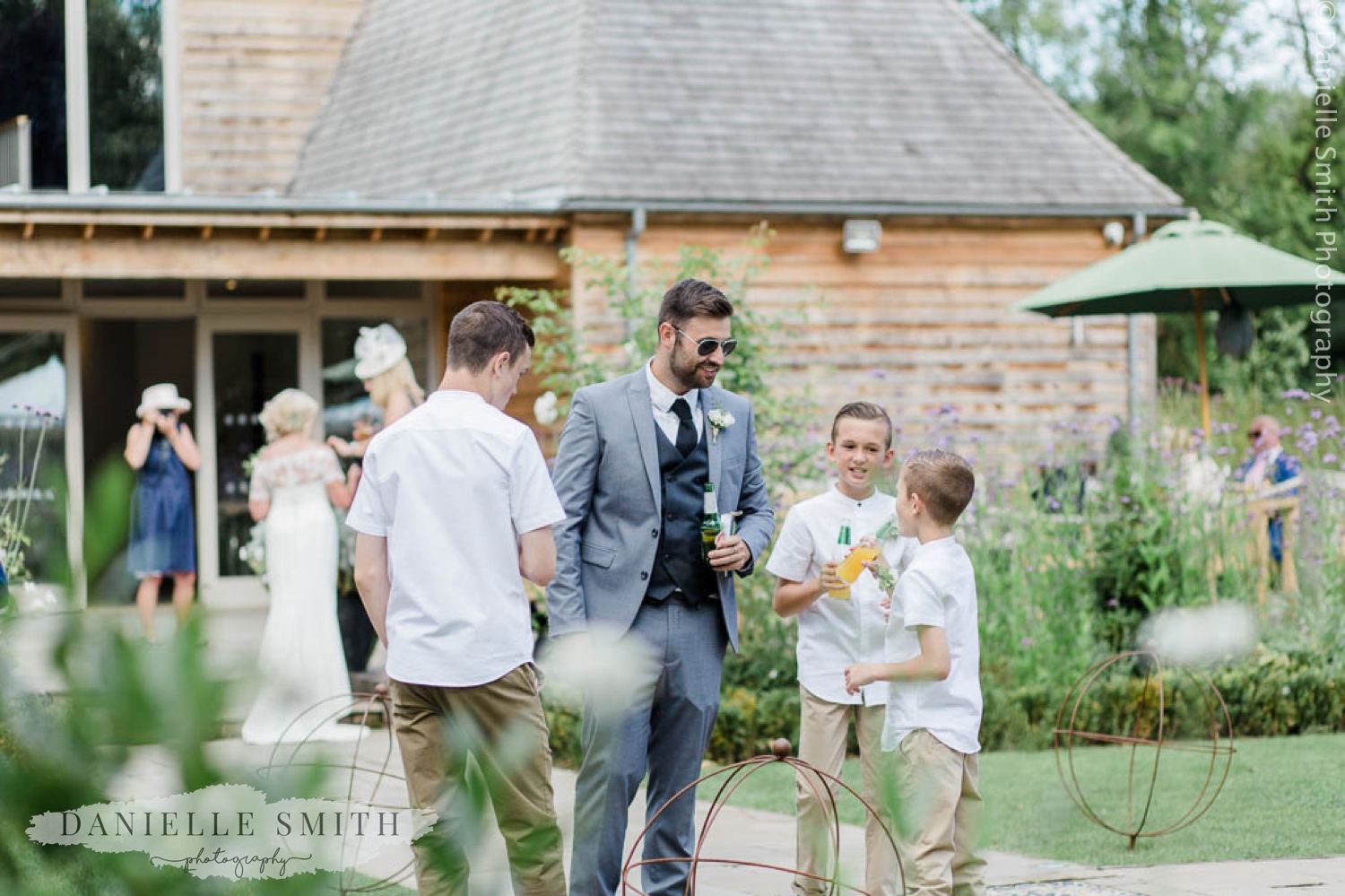 page boys and wedding guests in gardens