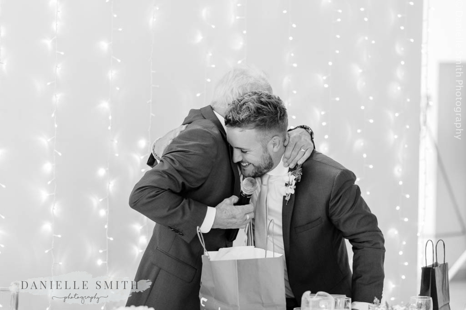 groom hugging his son after speech