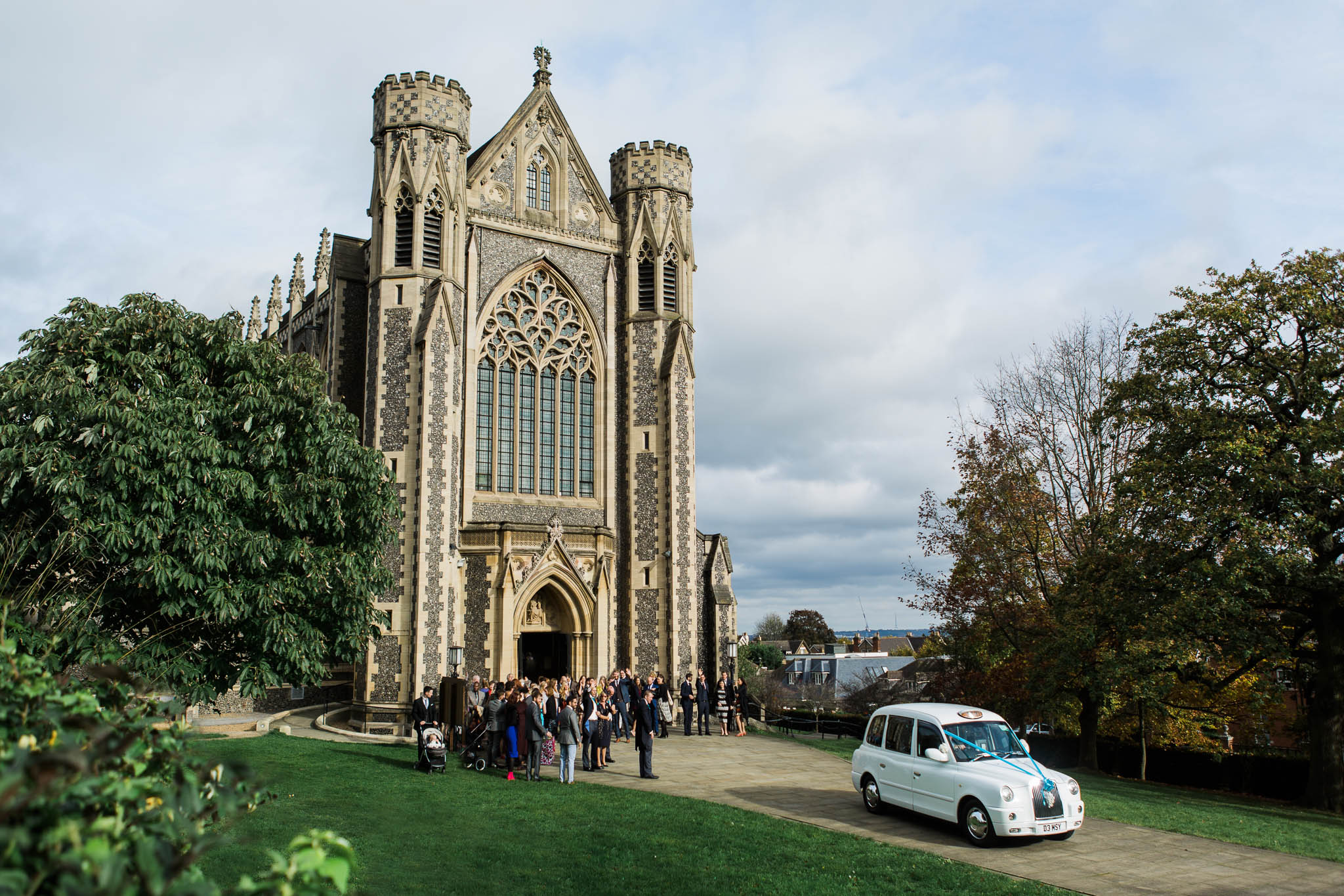 white taxi leaving church