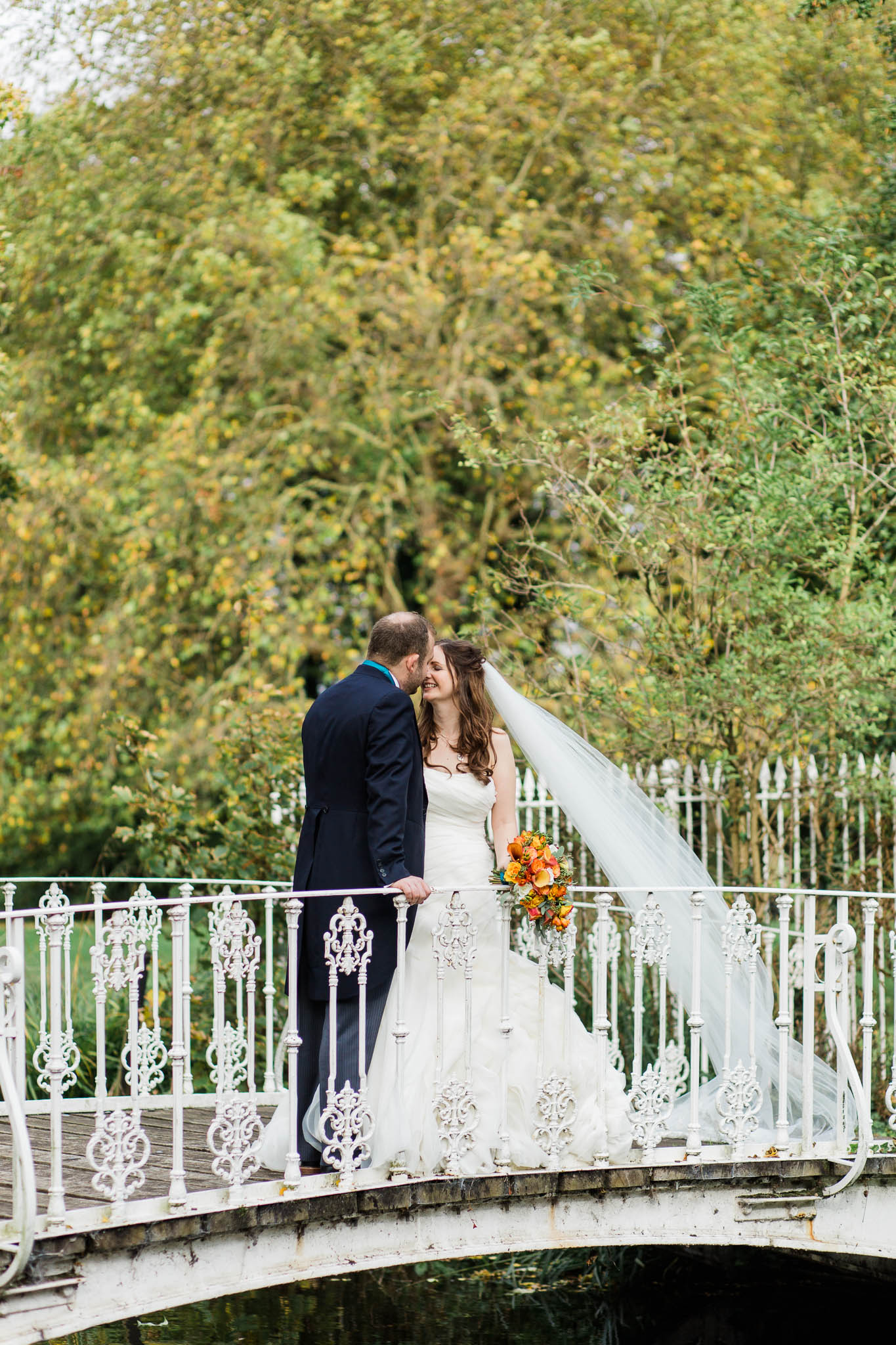 bride and groom on bridge - morden hall wedding