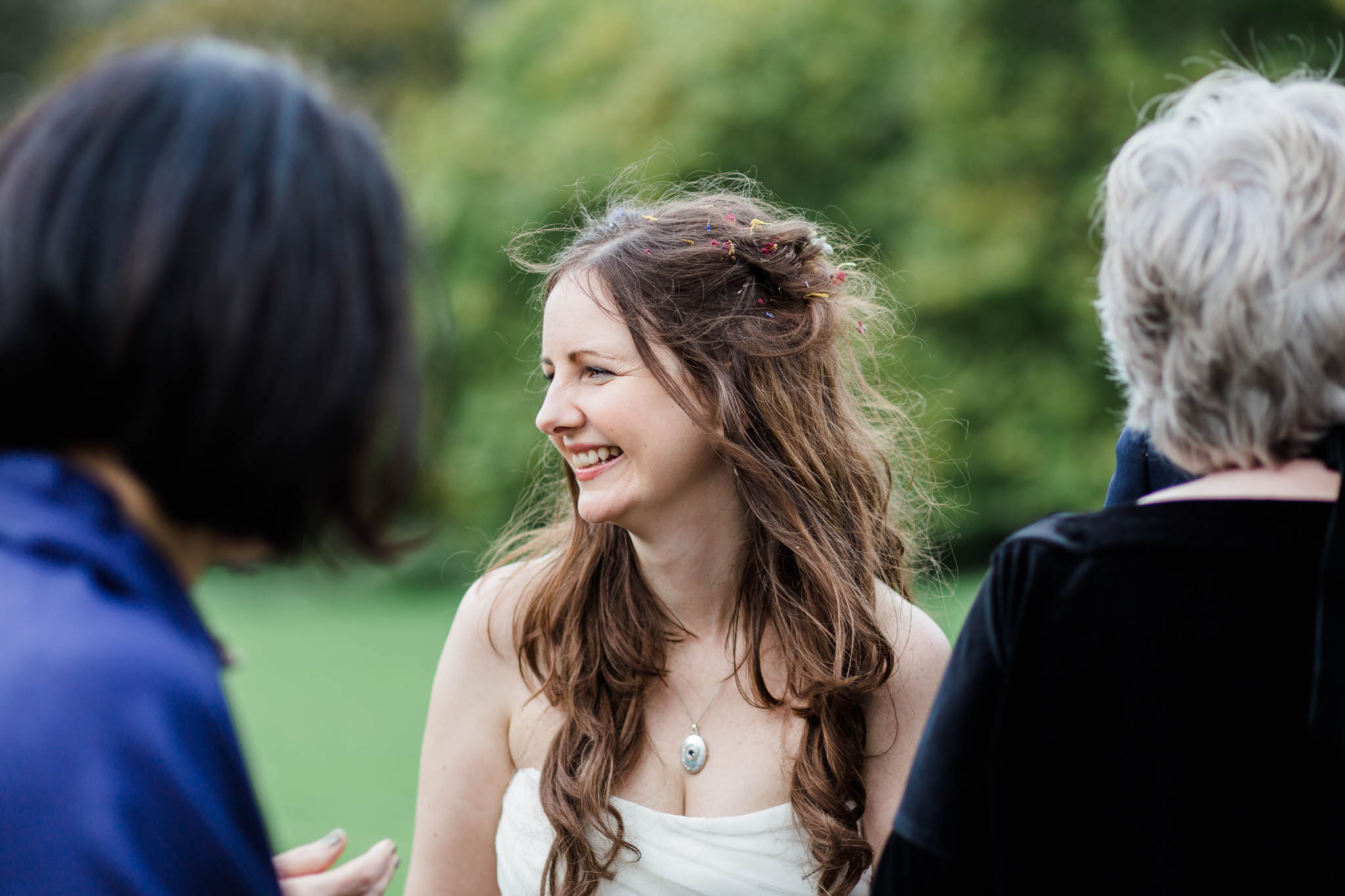 bride smiling with confetti in her hair