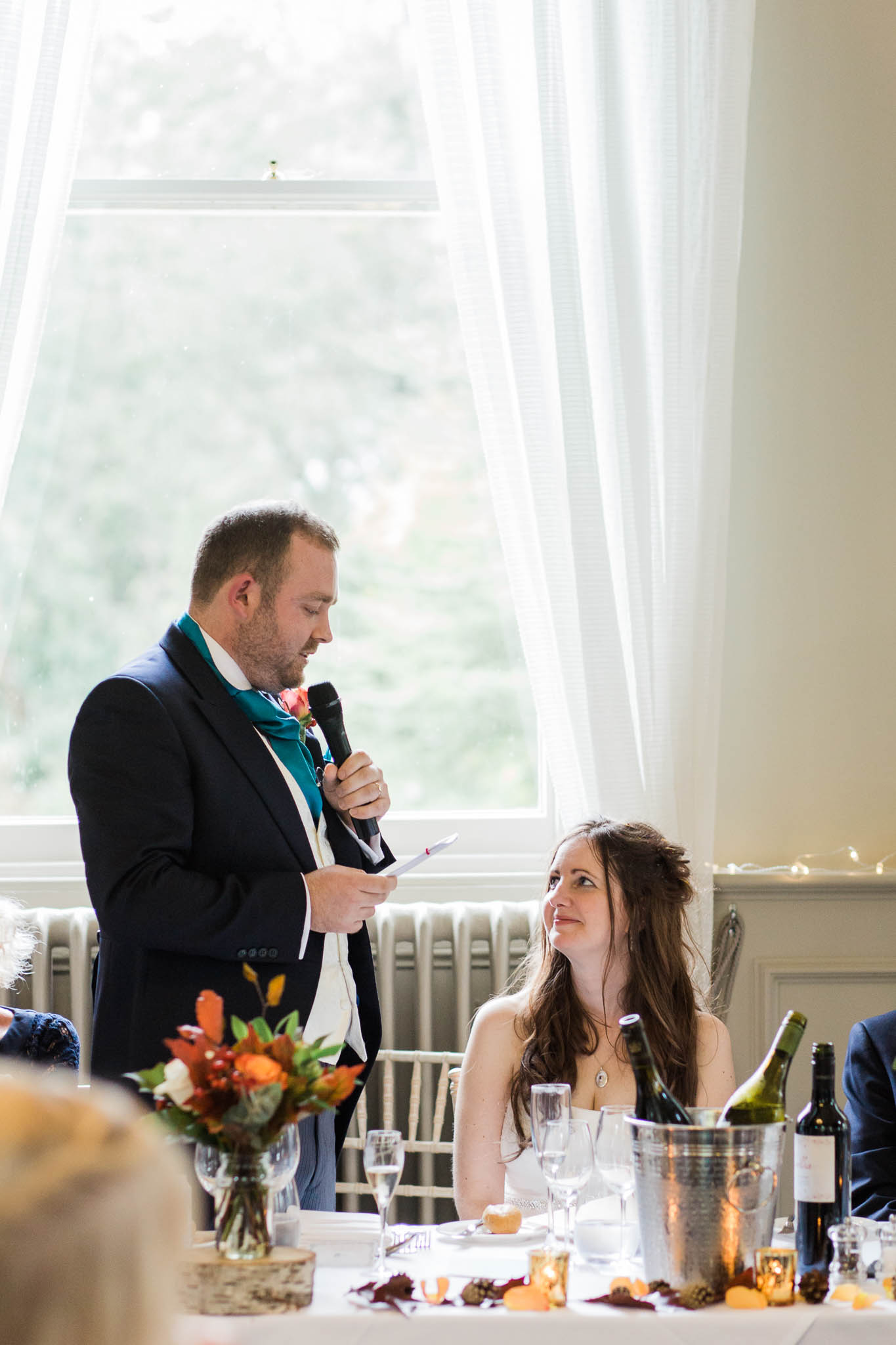 groom speaking to his wife during speech - morden hall wedding