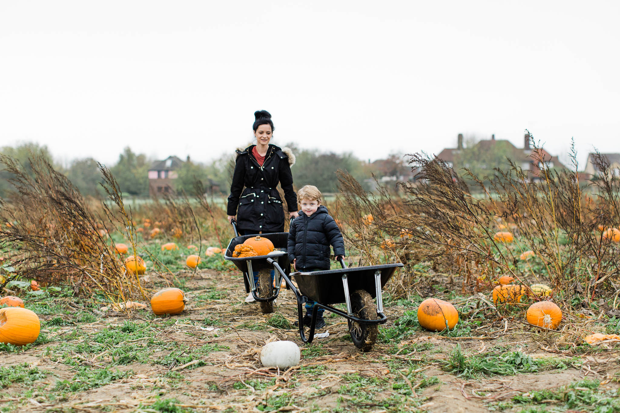 mother and son pumpkin picking