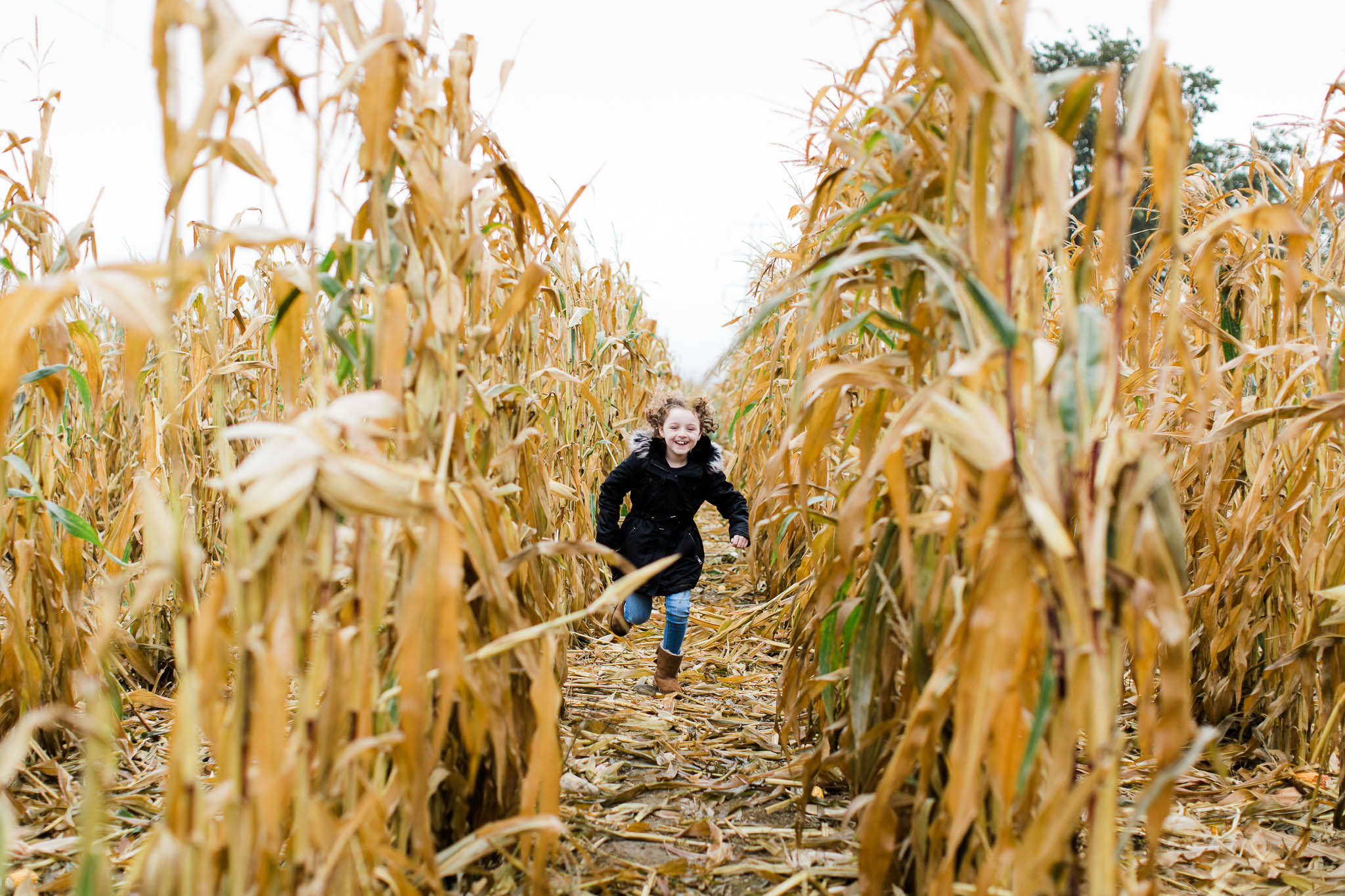 girl running through cornfield