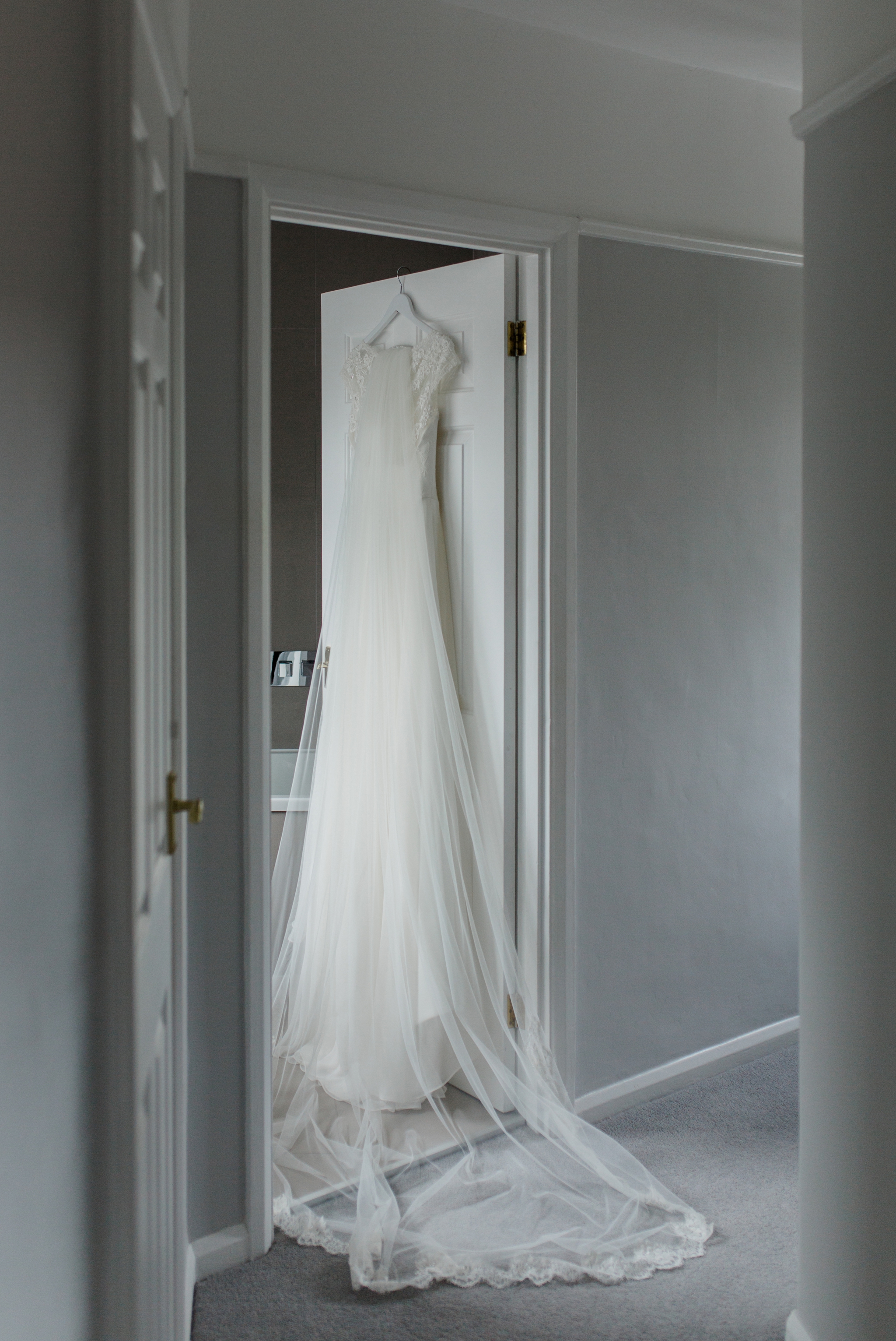 charlotte balbier wedding dress hanging on door