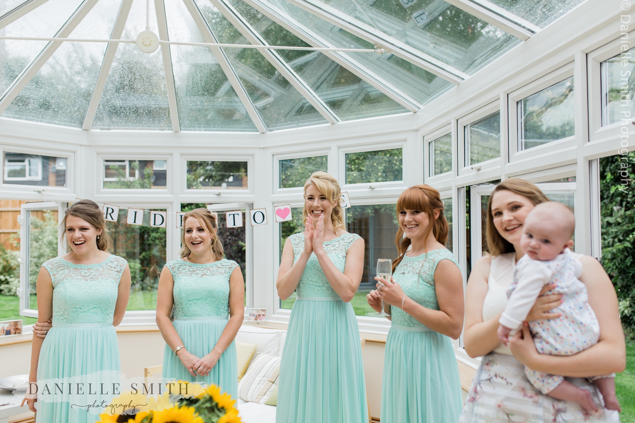 bridesmaids excited to see the bride in her dress