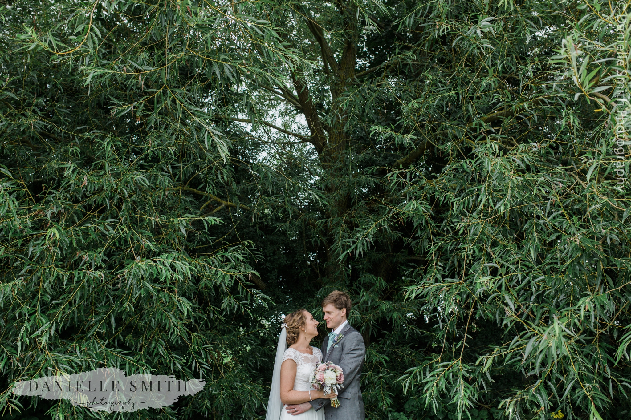 bride and groom looking at each other at garden wedding