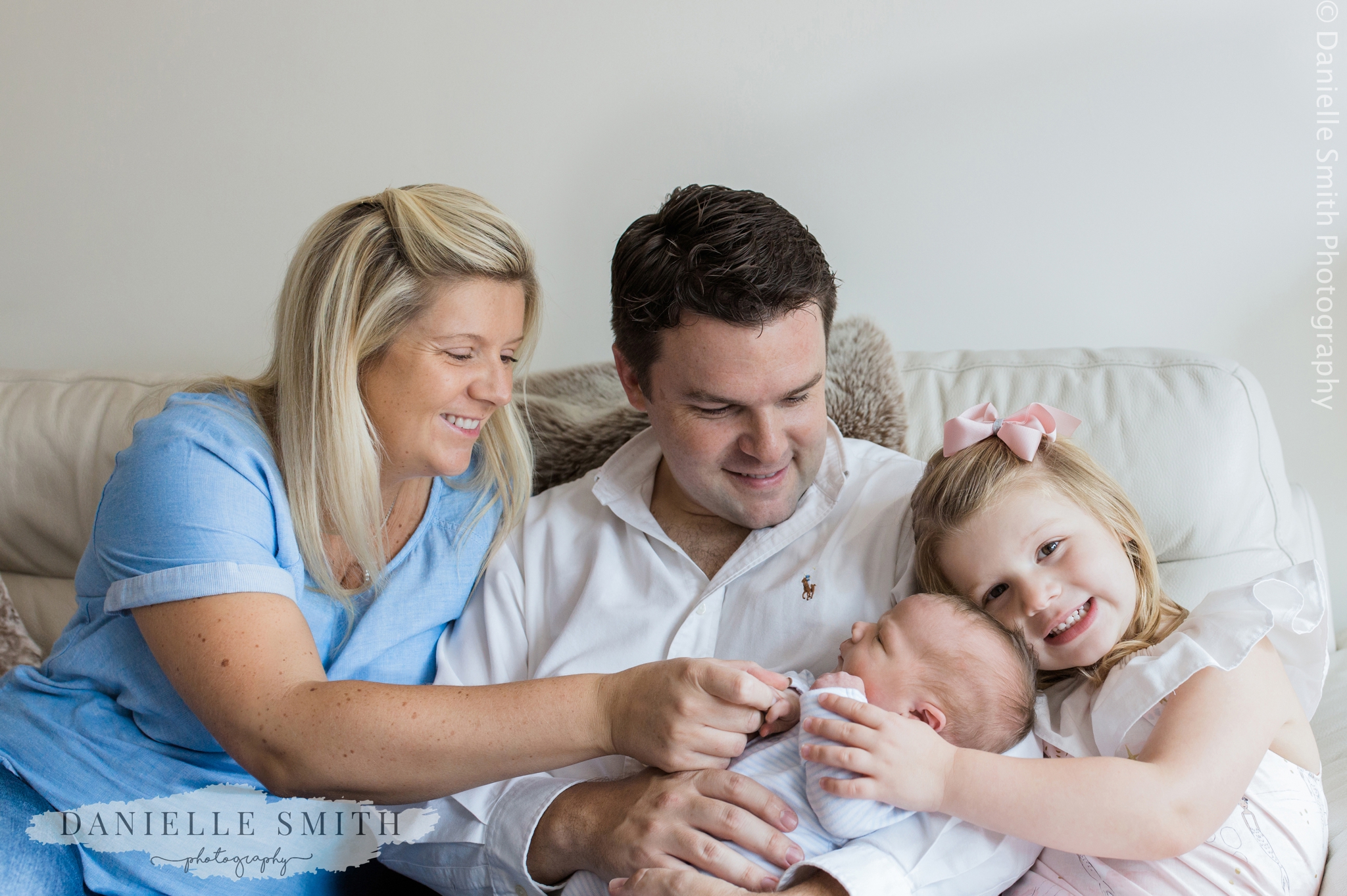family on sofa - newborn photography at home